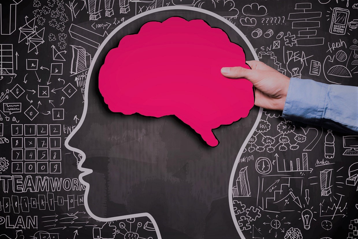 Businessman holding brain shape panel,  on blackboard with chaotic charts (Click for more)